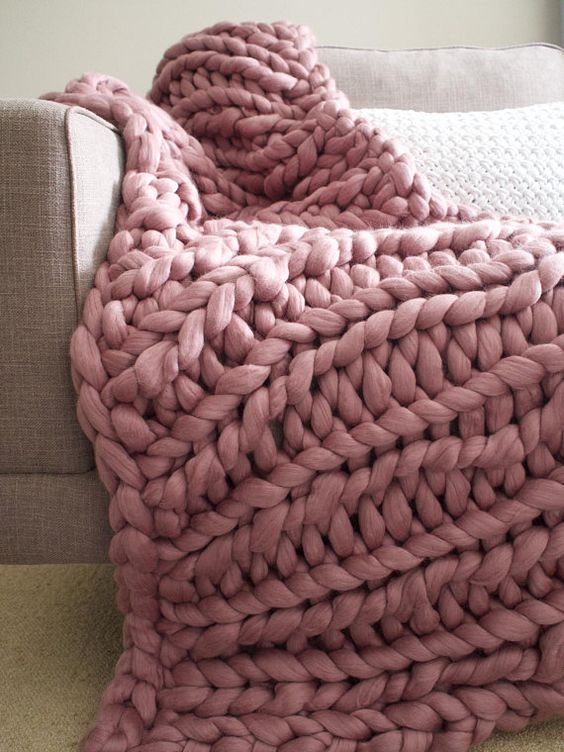 A chunky knit blanket in dusty pink is a very cozy idea for winter, which is on now