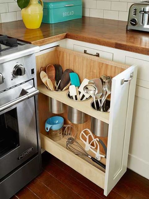 a pull out storage drawer that uses the dead space by the cooker and stores various cutlery