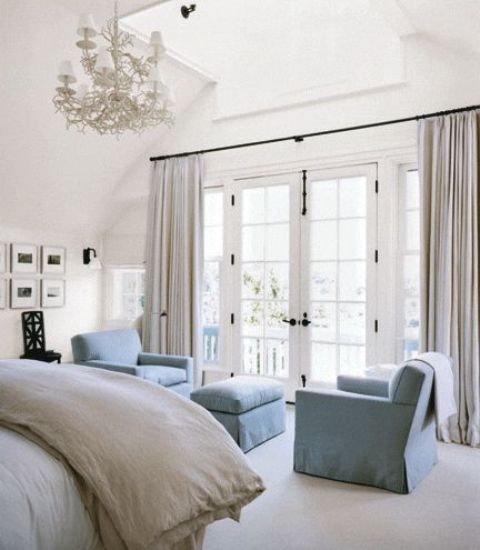 a chic nook of two powder blue chairs and an ottoman make a relaxing nook and add color to the space