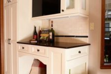 12 a home bar with an integrated dog bed and even dog feeding station on the side