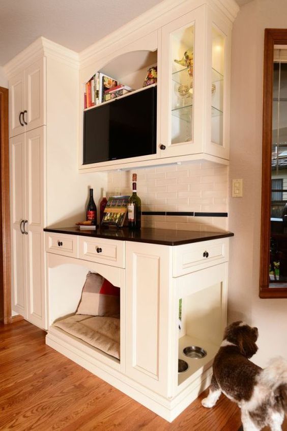 a home bar with an integrated dog bed and even dog feeding station on the side