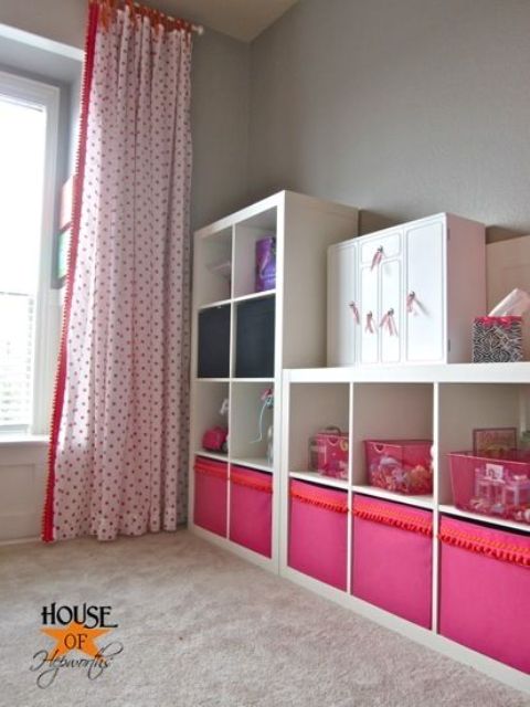 a kids' storage unit made of Expedit and of colorful Drona boxes with a pompom trim
