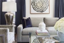 12 a stylish living room with grey furniture and navy pillows and curtains create a very chic and refined look