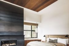 13 a fireplace completely covered with darkened metal is a gorgeous statement for a neutral bedroom
