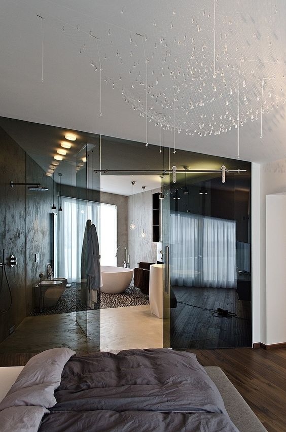 Separate the en suite bathroom from your bedroom with smoked glass doors to keep both spaces light filled and connected