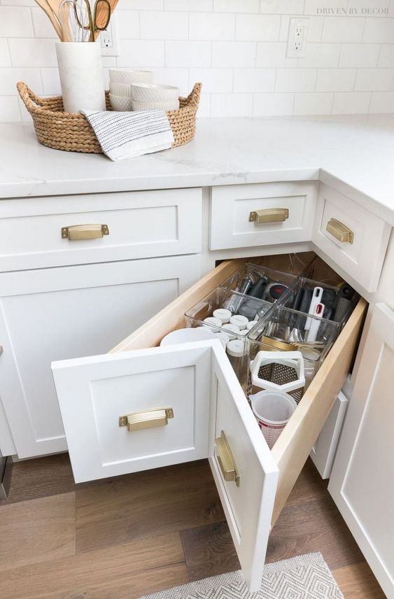a storage drawer in the corner is a nice idea to use that awkward space that is often unused