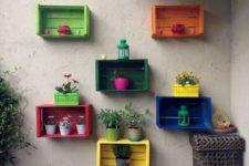 Knagglig boxes painted in bold shades and attached to the wall can be used as an outdoor garden