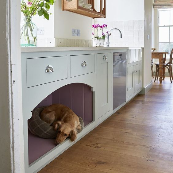 a kitchen cabinet with an integrated dog bed for him or her to stay by your side while you are cooking