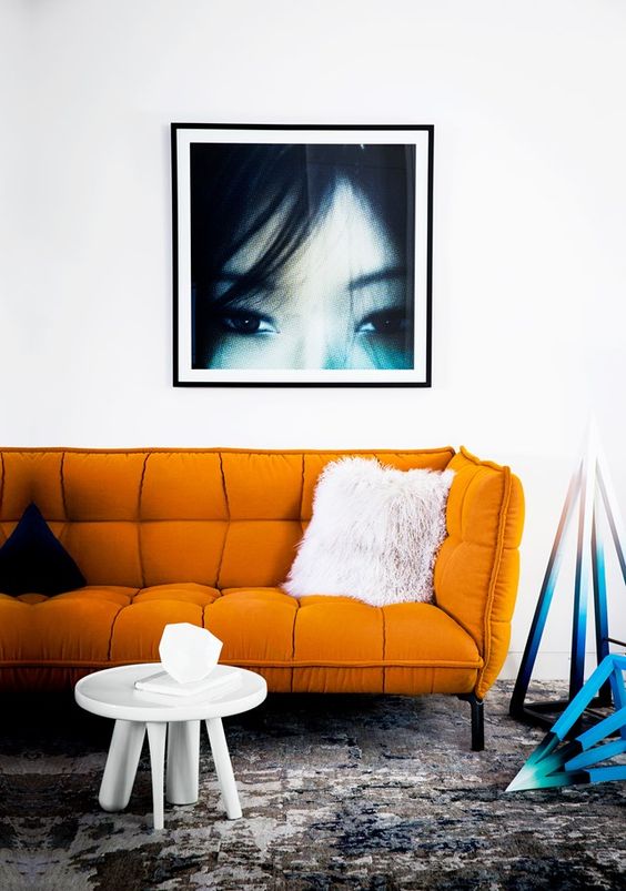 a modern orange sofa makes a statement with its catchy shape and bold color and texture