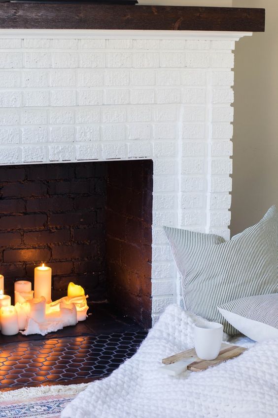if it's a faux fireplace, think of filling it with candles to make it look more natural