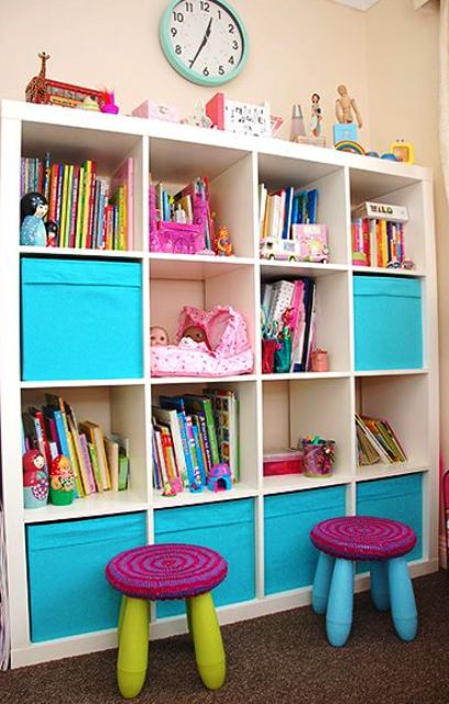 an Expedit shelving unit finished off with colorful IKEA Drona boxes for closed storage