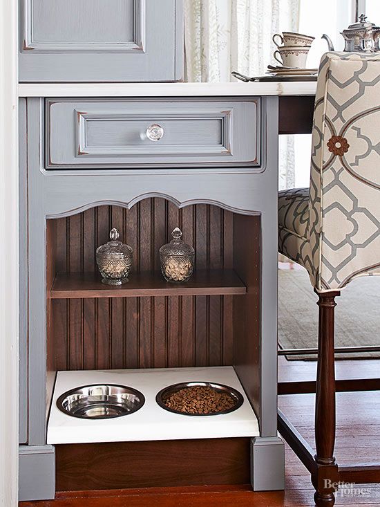 a cabinet with a elegant pet food station and some jars with treats on the shelf