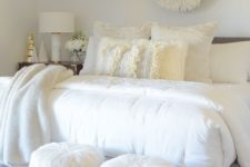 17 a cozying up printed rug, faux fur stools and fur throw blankets make the bedroom very inviting
