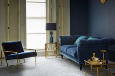 17 a refined living room with a grey floor, a navy wall, a navy sofa and chair