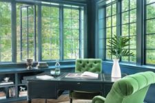17 a vintage-inspired elegant blue home office accented with a black desk and green velvet chairs