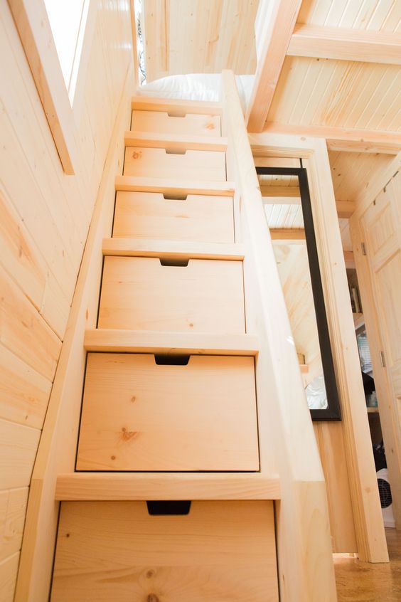 if you have a sleeping space on the second level, incorporate storage drawers into the ladder