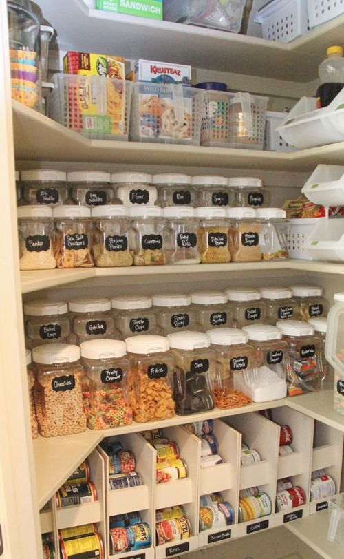 smaller and larger jars with labels and open drawers with the same labels give your pantry a cohesive look