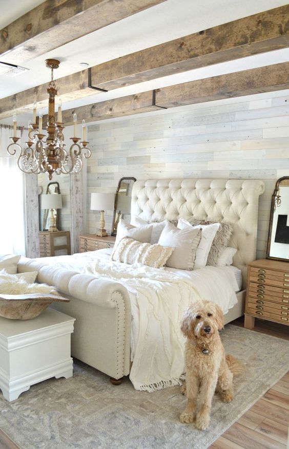 a neutral space with a neutral rug and a fringed blanket and fur pillows