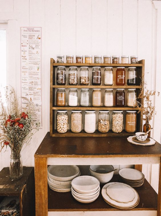 an open pantry idea with a shelving unit or several ones and the same jars with sharpie labels