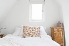 20 a tiny attic bedroom with a platform bed and a duo of shabby chic wooden bedside tables