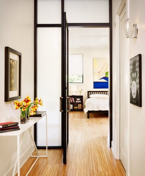 frosted glass doors, even with dark framing, separate your spaces gently without visually decresing the amount of space