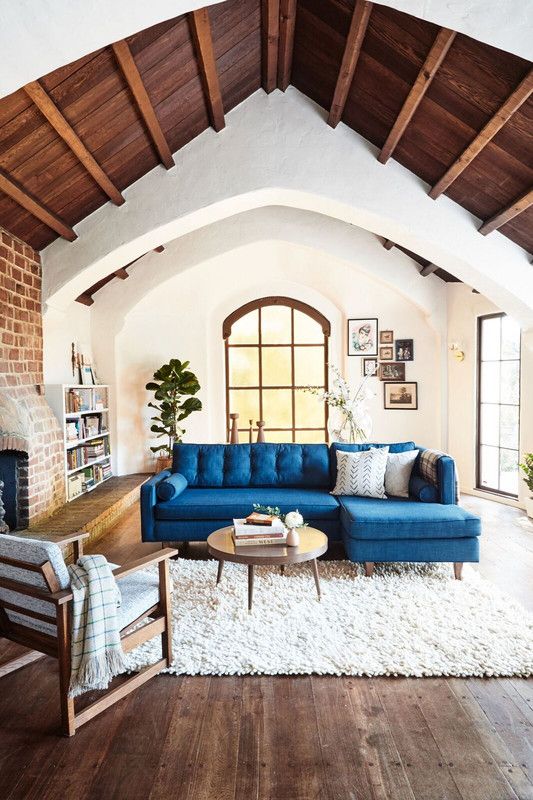 a bright blue L-shaped sofa adds color and interest to the space becoming its centerpiece