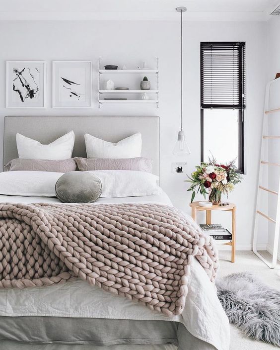 a chunky knit blanket and velvet pillows are right what you need to cozy up your bed