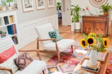 21 a tribal rug and pillows bring a boho feel to this mid-century modern living room