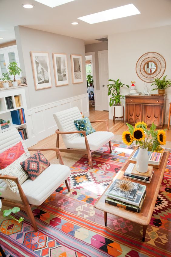 A tribal rug and pillows bring a boho feel to this mid century modern living room