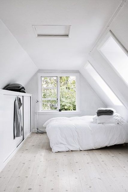 An airy space with a bed and a large built in storage unit is a very realxing idea