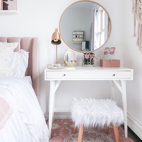 a simple dressing table that doubles as a bedside table with a stool covered with faux fur