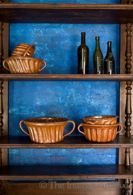 Paint the wall behind the shelves in bright blue to accent it and to create a bold contrast in the kitchen