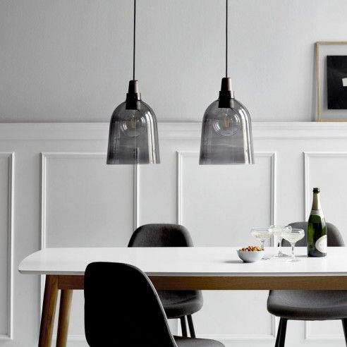 smoked glass pendant lamps over the dining table is bold and edgy idea to try