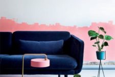 23 a living room with a catchy half pink wall and a refined navy velvet sofa
