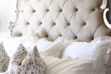 23 a neutral cutout tufted headboard with mirror touches is a chic and unusual idea