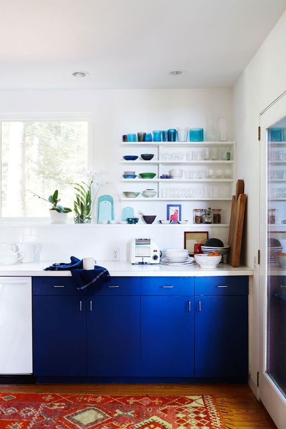 A neutral kitchen spruced up with a couple of electric blue kitchen cabinets