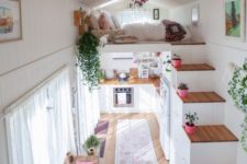 23 colorful rugs and potted plants plus curtains immediately cozy up the small home