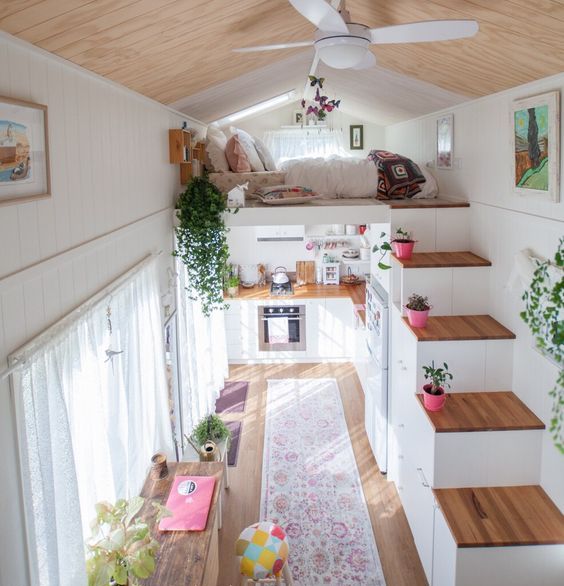 colorful rugs and potted plants plus curtains immediately cozy up the small home