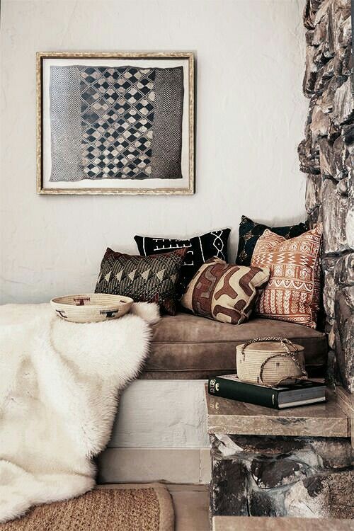 tribal printed pillows and a tribal basket and an artwork bring a wild feel to the space