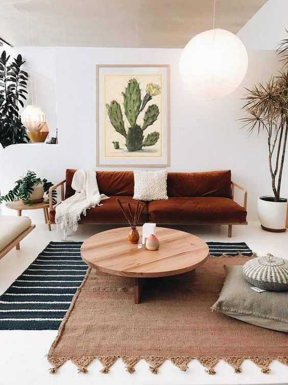 A striped rug, a woven one with tassels over it for a cool boho inspired living room