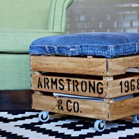 an industrial ottoman made of a stained Knagglig box with letters, with a denim seat and casters