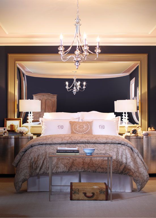 an oversized mirror instead of a headboard is a unique and very creative idea to try