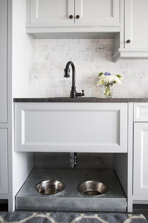 a sink cabinet with a pet food station underneath is a smart way to feed your pet with comfort