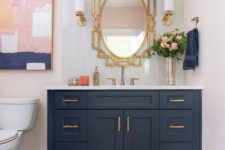 25 a stylish bathroom with a navy vanity, a blush printed rug and a catchy artwork that ties them both