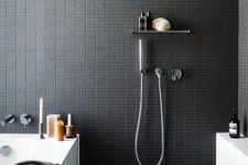 25 catchy small black tiles on the walls give your bathroom a sexy feel, and grey tiles on the floor make it calmer