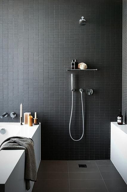 catchy small black tiles on the walls give your bathroom a sexy feel, and grey tiles on the floor make it calmer