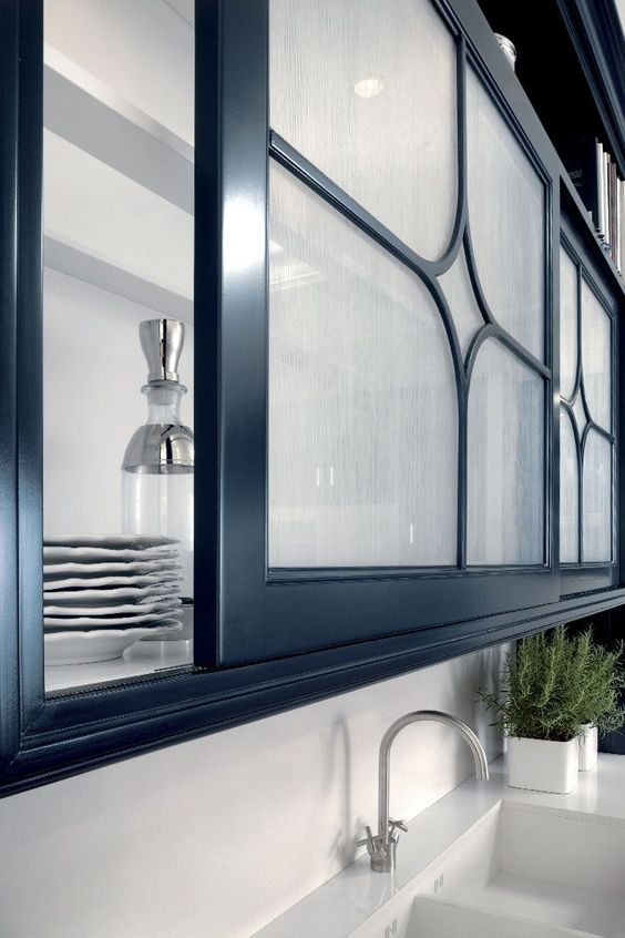 sliding screen doors with frosted glass and black touches for a refined and chic kitchen cabinet