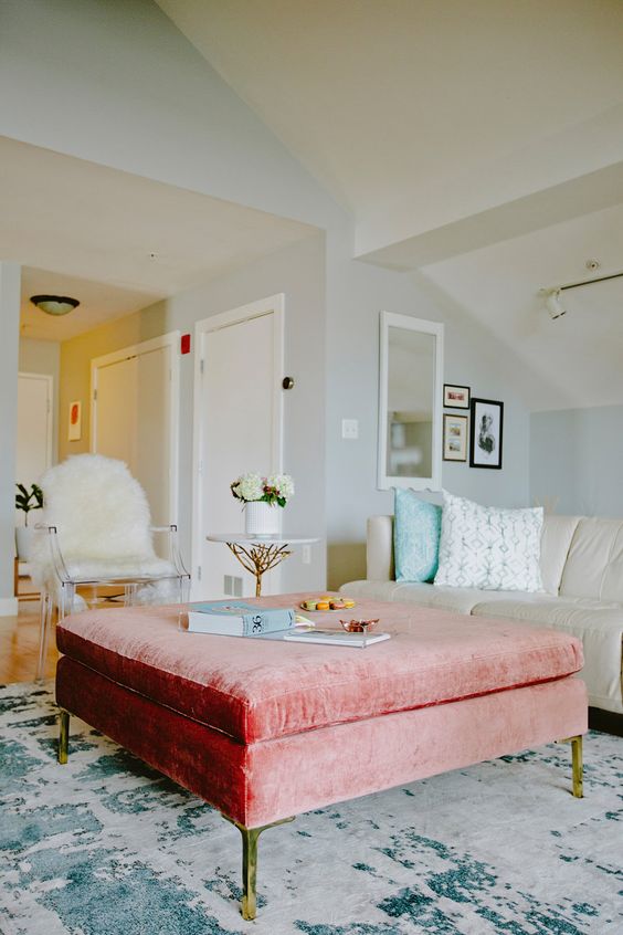 a peachy pink velvet ottoman with hidden storage can act as a coffee table or a seat