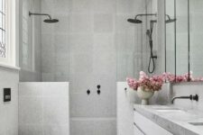 a grey minimalist bathroom with terrazzo tiles and a marble tile floor, a large vanity, a shower and a tub