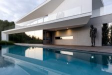 01 This gorgeous house features contemporary style, clean lines, moody colors and lots of works of art